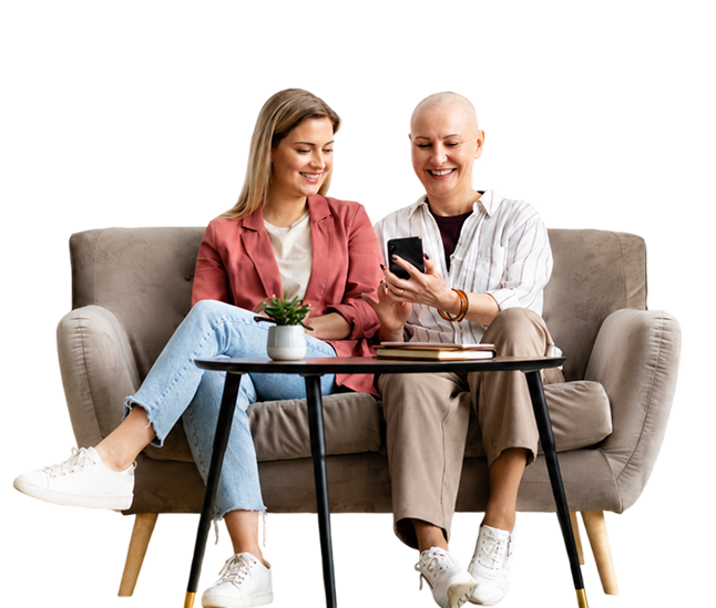 Two people smiling together on a sofa