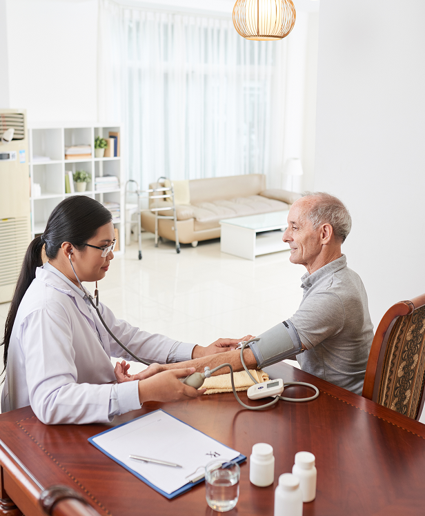 Doctor measuring a patient blood pressure during a house call