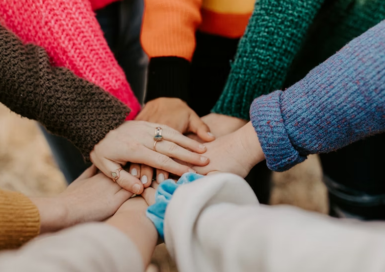 Hands joined together in a support circle