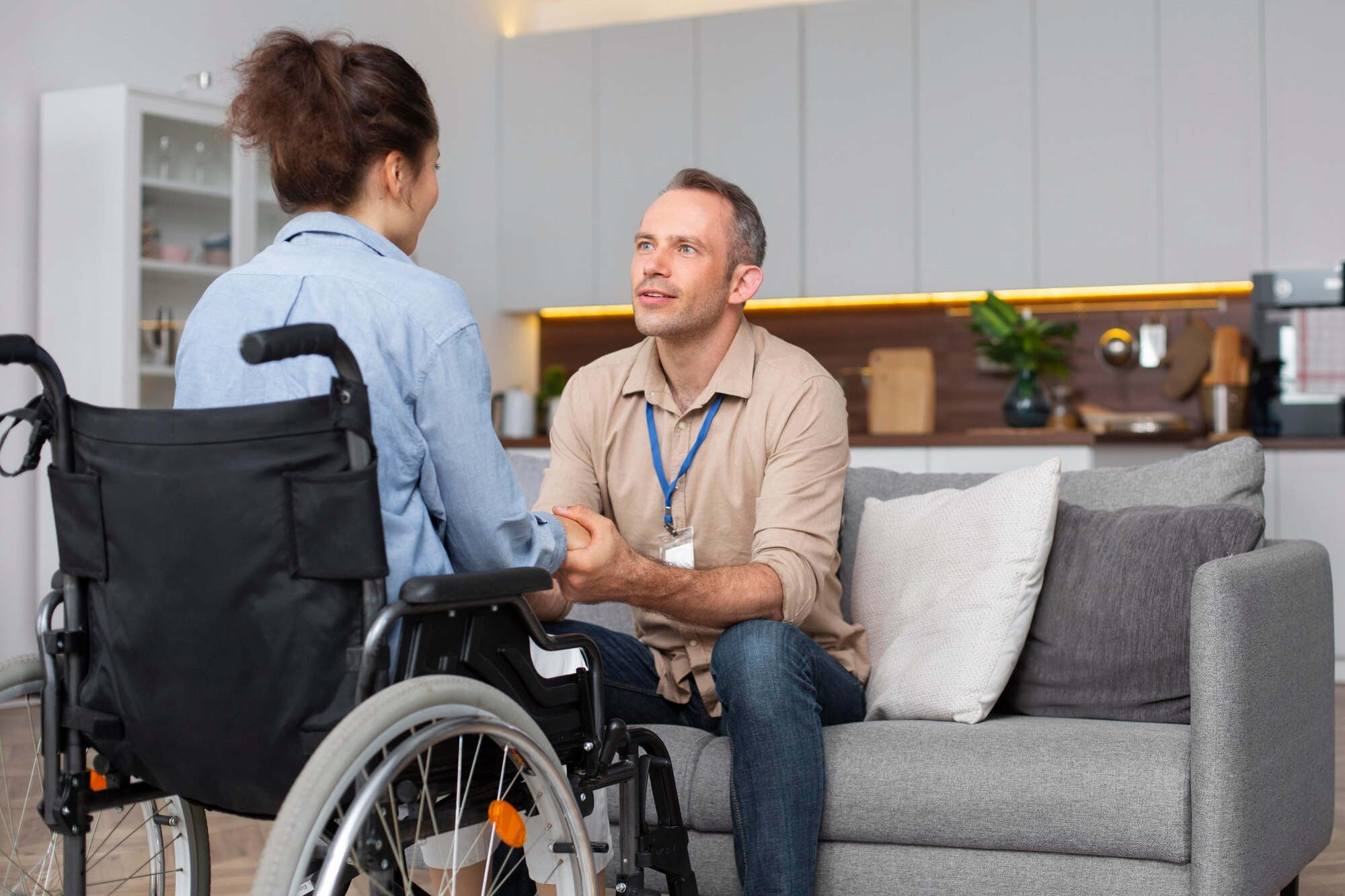 Caregiver speaking with person in wheelchair